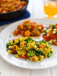 a white plate topped with eggs and veggies