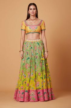 Editor's Note Yellow Embroidered U Neck Blouse with Yellow and Green Ombre SB Signature Embroidered Lehenga with Pink Suede Velvet Border and Embroidered Organza Scallop Dupatta. Fabric: Dupion, Pure Crepe, Organza Color: Yellow, Green Care: Dry Clean Only Disclaimer: Product Color May Slightly Vary Due To Photographic Lighting Sources Or Your Monitor Setting. About the Designer Siddhartha Bansal, label epitomise its design philosophy touring around " Golden bird" nation to present day India, in U Neck Blouse, Tassel Ornament, Pink Border, Embroidered Lehenga, Embellished Blouse, Beaded Neckline, Embroidered Wedding, Green Ombre, Wedding Lehenga