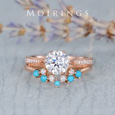 a diamond ring with turquoise stones on top and the words mohriings above it