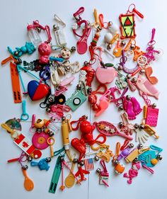 a pile of assorted toy items sitting on top of a white table next to each other