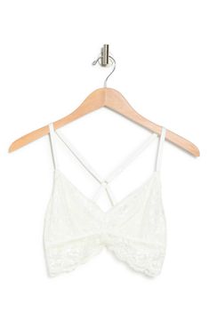 Delicate lace plays up the romantic charm on this soft cup bralette that features a strappy cross-back that will support you completely. 90% nylon, 10% spandex
 Machine wash cold, lay flat to dry Imported White Lace Bra With Adjustable Straps, White Lace Bra With Straps, Lace Cami Bra With Delicate Straps, White Lace Bra With Delicate Straps, White Bra With Delicate Spaghetti Straps, White Spaghetti Strap Bra With Delicate Straps, Spring Lace Bra With Delicate Straps, White Cami Bra With Adjustable Straps, Soft Cup