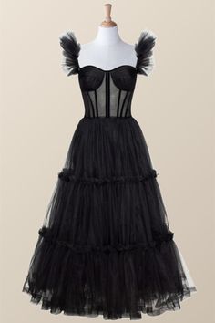 Turn heads in this timeless black corset dress! The A-line silhouette and tulle material create a soft, feminine look while the semi-transparent corset and ruffle straps add a hint of edgy elegance. The lace-up back and tea length complete the whimsical design. Elegant Fitted Corset With Tulle Skirt, Black Evening Corset With Fitted Bodice, Black Fitted Corset Dress With Ruffles, Black Corset Back Dress For Gala, Black Fitted Bodice Corset For Evening, Black Cocktail Corset With Lined Bodice, Cocktail Corset Dress With Ruffles And Fitted Bodice, Black Corset Dress For Cocktail With Fitted Bodice, Black Strapless Tulle Corset Dress