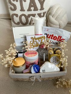 a basket filled with items sitting on top of a bed