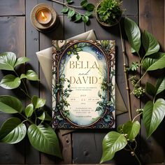 a card with the words bella and david on it surrounded by greenery, candles, and other items