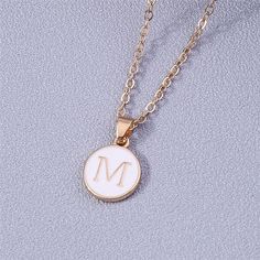 Add a personalized touch to your look with our YourLetter White Enamel Circle Necklace. Crafted with a white enamel background and gold color detailing, the necklace comes with a choice of single letter pendant. A great way to show off your initials or those of someone you love. Gold Initial Pendant Necklace With Letter Print, White Initial Pendant Necklaces For Mother's Day, White Minimalist Initial Necklace As Gift, White Initial Pendant Necklace For Mother's Day, Minimalist White Jewelry With Initial Pendant, White Initial Pendant Necklace With Monogram, White Initial Pendant Charm Necklace For Mother's Day, White Monogram Initial Pendant Necklace, White Monogram Initial Necklace