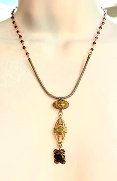 I made this  Art Deco, brass and antique Amethyst, garnet and gold rosary chain floral, art necklace. It measures 18 inches but also has a generous extender. Antique Beaded Chain Jewelry Gift, Antique Beaded Chain Jewelry As Gift, Antique Jewelry With Beaded Chain For Gifts, Antique Gold Spiritual Necklace With Vintage Charm, Spiritual Gold Necklace With Vintage Charm, Antique Garnet Pendant Necklace, Vintage Bronze Beaded Chain Jewelry, Vintage Brass Jewelry With Beaded Chain, Antique Style Necklace With Beaded Chain