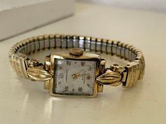 "Gorgeous 1950's Vintage German Art Deco gold plated 15 Jewels ladies wristwatch Harkoso with flexible bracelet. Very rare collectible 15 Jewels German mechanical  ladies watch in excellent condition. Dial is in a great vintage white to Champaign color. The bracelet is flexible and gold plated. An accent that would make every woman look stunning. Amazing present for vintage watch lovers. The watch is real treasure. Pre-owned. The item has been used previously. It may have some signs of cosmetic wear but is fully operational and functions as intended. Selling in as found condition. Checked and serviced. Exceptional gift for the loved one. It is a striking looking watch with no visible defects except the age patina on the dial. Watch runs properly when tested. Should be wound regularly. The Luxury Antique Jewelry And Watches For Evening, Luxury Antique Rectangular Watch, Adjustable Vintage Watch Accessories, Luxury Vintage Watches For Formal Occasions, Cheap Vintage Formal Watch, Luxury Vintage Watch Accessories With Tachymeter, Cheap Vintage Formal Watches, German Ladies, Art Deco Watch