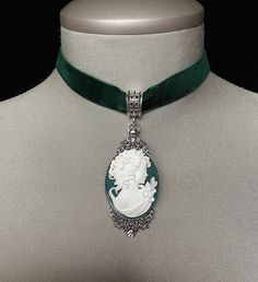 Velvet choker! A beautiful and unique "forest green" and white cameo has been set in an antique silver pendant and attached to a forest green velvet choker.... The cameo measures 1 1/4" in width and 2" in height... An 4" antique silver extension chain has been attached to the back clasp with a teardrop pearl added to the end of the chain.... Please select if you would like this item gift wrapped....I will also enclose a quality gift card with your special message.... Thank you for taking time to browse my shop "Veronica Rose Designs" Victorian Cameo, Vintage Choker, Velvet Choker, Cameo Necklace, Jewelry Bridal, Vintage Velvet, Bridal Necklace, Green Velvet, Forest Green