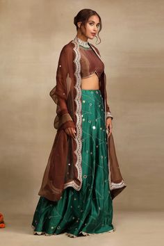 Emerald green and brown silk chanderi lehenga with bloom bud zari thread, mirror and dabka embroidery all over. Paired with a blouse embellished with sequin-dabka work on neckline and sleeves and a dupatta adorned with sequin lace detailing on the edges. - Aza Fashions Festive Tussar Silk Floor-length Sets, Festive Floor-length Tussar Silk Sets, Bollywood Style Tussar Silk Sets With Sheer Dupatta, Festive Tussar Silk Sets With Sheer Dupatta, Brown Resham Embroidered Sets For Diwali, Festive Lehenga With Sheer Dupatta In Tussar Silk, Diwali Tussar Silk Sets With Sheer Dupatta, Brown Resham Embroidery Sets For Diwali, Tussar Silk Sets For Reception And Navratri