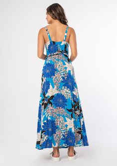 A figure-flattering sleeveless maxi wrap dress in a bright blue floral print. This effortless maxi dress will have you feeling pulled together in a pinch. Featuring a wrap front with a side tie closure, a plunging v-neckline, and a flowy long skirt. The bold blue floral print adds a tropical feel. Floral print Relaxed, flowy fit Sleeveless Maxi length Wrap front Plunging v-neckline Adjustable tank top straps with concealed button closure Side tie closure Flowy bohemian maxi dress Model is 5'9, w Floral Print Maxi Wrap Dress For Beach, Floral Print Maxi Wrap Dress For Vacation, Blue Surplice Neckline Wrap Dress For Beach, Blue Wrap Dress With Surplice Neckline For Beach, Turquoise Maxi Dress For Vacation, Blue Maxi Wrap Dress With Tie Waist, Casual Turquoise Floral Print Maxi Dress, Casual Turquoise Maxi Dress With Floral Print, Casual Blue Maxi Dress With Surplice Neckline