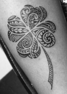 a black and white photo of a shamrock tattoo