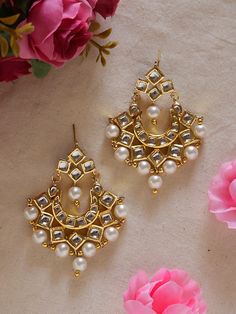 Add a touch of timeless elegance to your jewelry collection with these beautifully crafted golden kundan earrings lined with small jhumkas.  Designed with intricate details and high-quality materials, these earrings are the perfect accessory to elevate any outfit, whether it's for a special occasion or adding some glamour to your everyday look. The stunning golden color of these earrings makes them versatile and easy to pair with any outfit. The intricate design of the kundan setting adds a touc Small Kundan Earrings, Elegant Festive Jhumkas With Mirror Work, Elegant Kundan Jhumkas With Gota Work, Elegant Jhumkas With Mirror Work For Diwali, Elegant Diwali Jhumkas With Mirror Work, Elegant Mirror Work Jhumkas For Diwali, Gold Temple Jewelry Tikka With Mirror Work, Gold Kundan Necklace With Matching Earrings, Elegant Earrings With Mirror Work For Diwali