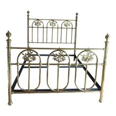 a metal bed frame with flowers on it