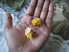 A lovely pair of vintage 1950's realistic celluloid floral screw back earrings. Each earring measures 1 1/8'' x 1 1/8''. In good vintage condition. Vintage Flower Clip-on Earrings For Wedding, Vintage Yellow Flower Earrings, Vintage Flower Shaped Earrings For Anniversary, Vintage Flower Earrings For Anniversary, Vintage Flower Earrings For Wedding, Yellow Flower Earrings For Wedding, Vintage Flower Earrings, Vintage Celluloid, Earrings Wedding