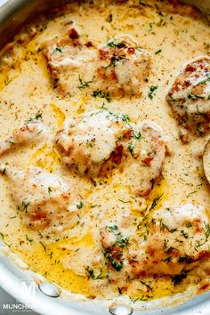 a pan filled with chicken and cheese covered in gravy