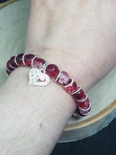 A red crackle glass beaded stretch bracelet with silver embellishments to make a statement on anyone's wrist! This everyday bracelet is great to wear with anything. Red Charm Bracelet is great for the boho style for anyone. Red beaded stretch bracelet, simple minimal bracelet with lots of boho style! DETAILS: *Stretch cord for one size fits most * 8mm red crackle glass beading * Silver heart charm BUY THIS BRACELET AS A 3PC SET WITH THE NECKLACE AND EARRINGS HERE: https://www.etsy.com/listing/70 Silver Heart Jewelry, Red Gothic, Red Earrings Stud, Red Charm, Gothic Bracelet, Red Beaded Bracelet, Glass Beads Jewelry, Crystal Jewelry Sets, Bracelet Love