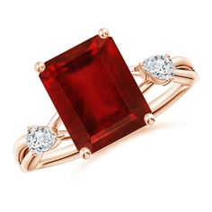 a red stone ring with two diamonds on it