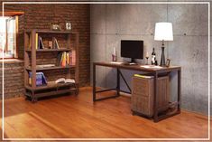 a computer desk sitting on top of a hard wood floor next to a book shelf