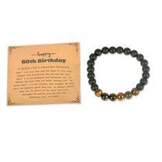 a bracelet with a happy 60th birthday message on it and a card for the man