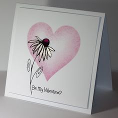 a valentine's card with a pink heart and daisies in the center, which reads be my valentine?