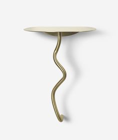 a table with a curved metal handle on it