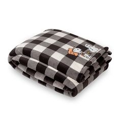 two black and white checkered blankets folded on top of each other with cartoon characters