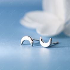 This pair of tiny crescent moon stud earrings is made of authentic 925 sterling silver, highly polished for a great shine. Experience the subtle elegance and beauty of these tiny sterling silver moon stud earrings, handcrafted from 925 sterling silver and polished to perfection. Each pair is a stunning addition to any outfit, adding a touch of celestial charm that will draw compliments and elevate your style. With their high-quality construction and brilliant shine, these earrings are a must-hav Moon Stud Earrings, Moon Studs, Subtle Elegance, Silver Moon, Silver Earrings Studs, Crescent Moon, Crescent, Jewelry Collection, 925 Sterling Silver