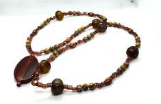 Necklace beaded with Jasper, glass, and Agate focal beads. Finished with a copper clasp.  Jasper is a protective stone. Agate helps to dissipate or eliminate negativity.  It is a calming and spiritually healing stone. Agate Necklace, Focal Bead, Healing Stones, Agate, Copper, Beaded Necklace, Jewelry Necklaces, Stone, Beads