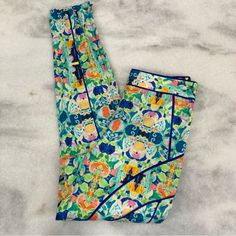 Milly Bright Colorful Tile Print Abstract Patterned Spring Summer Light Weight High Rise Ankle Pant With Contrasting Seam Detail In Silk. Side Zip, Hidden Zippers At Leg. Unlined. Color Tones Of Green, Blue, Orange, Yellow And Pink. New With Tags. Size 4 Waist 14” Across, Rise 10.5”, Inseam 29” Measurements Are Approximate Pictures Are Part Of The Description-Please Zoom In. Ask If You Have Any Questions. Thank You For Checking Out My Closet Shorts Leggings Tan Beige Nude Black White Pink Green Green Bottoms With Vibrant Print For Vacation, Casual Multicolor Floral Print Pants, Patterned Pants With Elastic Waistband For Spring, Spring Patterned Loungewear Pants, Blue High Waist Printed Bottoms, Blue High-waist Printed Bottoms, Spring Multicolor Print Pants With Elastic Waistband, Green Vibrant Print Summer Pants, Spring Multicolor Print Bottoms With Elastic Waistband