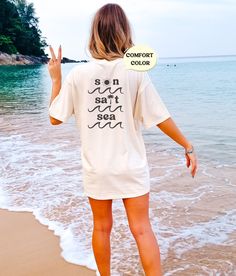 These cute beachy, distressed tees make a perfect beach coverup or lounge tee! Or mix and match colors with friends for a perfect group vacation photo! Please note that this design comes in black ink only, and is only on the back of the tshirt! About Comfort Colors Tees! (Unisex Shirts!) These ultra soft pigment dyed shirts are one of our best sellers ⭐️ 100% ring spun cotton ⭐️ PRESHRUNK, soft-washed, garment-dyed fabric ⭐️ Set-in sleeves ⭐️ Double-needle stitched sleeves and bottom hem ⭐️ Twill taped shoulder-to-shoulder ⭐️ 1" ribbed collar with double-needle topstitched neckline HOW TO PLACE AN ORDER 1. View all color and size charts before you place your order. 2. Select your shirt "SIZE" and "COLOR". 3. Click add to cart **Repeat process for each tshirt WASHING INSTRUCTIONS Use cold w Relaxed Summer Loungewear T-shirt, Relaxed Summer T-shirt For Loungewear, Relaxed Beach Cover-up Tops, Summer Oversized Relaxed T-shirt, Relaxed Short Sleeve T-shirt For Vacation, Oversized Casual T-shirt For Beach Season, White T-shirt For Beach Vacation, Summer Beachwear T-shirt With Relaxed Fit, Oversized Summer Beach Cover-up Top