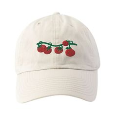 a white hat with cherries embroidered on the front and back, sitting against a white background