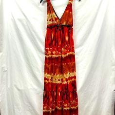 Nwot Boho Maxi Dress Beautiful Tie Dye Colors Of Orange, Rust, Red, And Beige, Low Cut, Brown Laced Tie That Ties In Back With Circle Pendant In Front, Upper Back Has Tie As Well, Ruffled Bottom Layer, Measures 57” Top To Bottom, Style With Sandals Or Wedges. Red Lined Sundress For The Beach, Red Lined Maxi Dress For Summer, Flowy Red Maxi Dress, Red Sleeveless Maxi Dress For Festival, Casual Orange Maxi Dress For Festivals, Red Lined Maxi Dress For Vacation, Casual Red Lined Maxi Dress, Casual Orange Dress For Holiday, Maxi Summer Dress