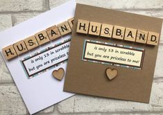 two greeting cards with scrabbled words and hearts on them, one says husband