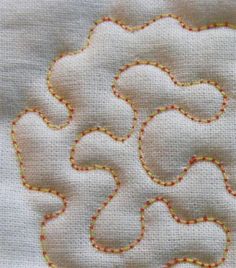 a close up of a piece of cloth with some stitching on the side and an applique in the middle