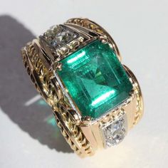 For Sale on 1stDibs - Ring in 18 karat yellow gold, eagle head hallmark and platinum. Incredible jewelry ring of the 1940s, it is decorated with a degrees- cut emerald and held Antique Emerald Diamond Ring For Formal Occasions, Antique Green Diamond Ring For Formal Occasions, Antique Emerald Ring In Stamped 14k Yellow Gold, Vintage Green Emerald Ring Gia Certified, Antique Yellow Gold Emerald Ring, Antique Emerald Ring In Yellow Gold, Fine Jewelry Yellow Gold Emerald Ring For Collectors, Fine Jewelry Green Signet Ring With 17 Jewels, Vintage White Gold Emerald Ring Hallmarked