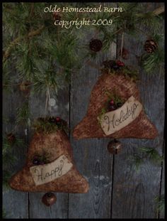 two christmas ornaments hanging from a tree with the words happy holidays written on one ornament