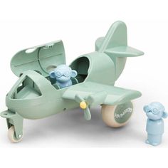 a green toy airplane with a baby in it's seat next to a blue dummy