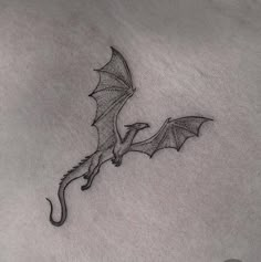 a small dragon tattoo on the stomach