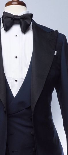 The classic navy tuxedo is a staple of any man's wardrobe. This elegant single-breasted Evening Wear tuxedo is tailored slim from soft, mid-weight, true blue mohair, and features our signature one-button placement, double vents, jetted pockets, natural shoulder, and wide peak lapels in grosgrain. The accompanying slim trousers are flat front with a wide waistband and feature our versatile side adjusters and classic tuxedo stripe. Bruce Buffer, Navy Blue Tuxedo, Blue Tuxedo Jacket, Red Overcoat, Brown Chukka Boots, Mens Wedding Suits, Navy Blue Tuxedos, Navy Tuxedos, Blue Tuxedo