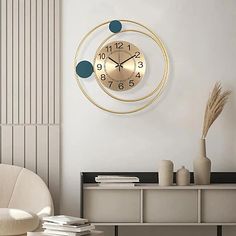 a clock that is on the side of a wall next to a chair and table