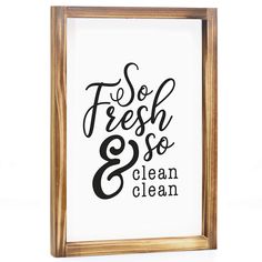 a sign that says fresh and so clean is hanging in a wooden frame on the wall