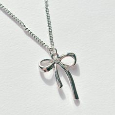 Stainless steel bow necklace.  16 inches in length. Matching navel piercing and earrings available on my page. An amazing gift idea for a friend, family member, or girlfriend 🦭 This is a handmade item so please treat me with care, this includes drying after wet and storing appropriately. All items on my page are BRAND NEW. If you have any questions feel free to send a message! 🫶🏻 Items are posted via RoyalMail. UK Shipping expected estimation 2-5 working days, international shipping expected Bow Ribbon, Bow Necklace, Navel Piercing, Necklace Minimalist, Charm Pendant Necklace, Jewellery Gift, Minimalist Style, Ribbon Bows, Minimalist Fashion