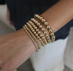 Beautiful and easy to wear, this real 14K gold filled bracelet set is the perfect finishing touch to your look. Stack alongside your favorite chain link bracelets for a stunning statement A statement piece for stacking Gold Filled Bead Bracelets L E T S . T A L K . B R A C E L E T S . ✤ Available in real 14k Gold Filled. ✤ Available  beads Size 3, 4, 5, and 6mm  gold filled ✤ Tarnish resistant ✤ Made with strong nylon stretch cord ✤ Maid to fit your size  ✤ Available sizes: 6", 6.5", 7", 7.5" and 8" *Please choose in drop down box ✤ S I Z I N G  ✤ How to measure your wrist or ankle size: Take a yarn or string wrap it around your wrist and cut it when the ends meet. Take the piece of yarn and measure it on a ruler. choose your size in drop down box All purchased items will arrive in a Tomma Elegant 14k Gold-filled Bracelets With 8mm Beads, Elegant 14k Gold-filled 8mm Beaded Bracelets, Gold 14k Round Beaded Bracelet, Gold 14k Beaded Bracelets With Round Beads, Elegant 14k Gold-filled Stretch Bracelet With Gold Beads, Elegant Stretch Bracelet With 14k Gold-filled Gold Beads, Dainty Yellow Gold Bracelets With 8mm Beads, Yellow Gold Bracelets With 8mm Beads For Everyday, Gold 14k Gold-filled Round Beads Bracelets