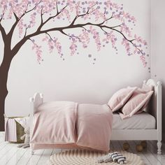 a bedroom with a tree painted on the wall