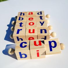 wooden blocks with letters spelling out the word run up on top of each other in blue, red and yellow