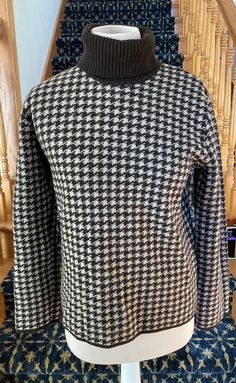 This classic sweater features an all-over houndstooth pattern in chocolate brown and camel, a ribbed fold-over turtleneck, and brown tipped cuffs and hem.  Substantial weight knit.  Very good vintage condition.  Made in Hong Kong.  Dry clean. 100% Merino Wool Label says size XL but seems like a modern size M.  Does not feel like it was shrunken. Bust Body Length Sleeve Length Pullover Outfit, Classic Sweater, Houndstooth Pattern, Women Pullover, Chocolate Brown, Pullover Sweaters, Sweater Outfits, Merino Wool, Hong Kong