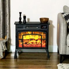 a living room with a couch and a fire in the fireplace next to a chair