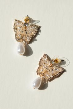 Add a touch of whimsy to your jewelry collection with these 14K gold plated stud earrings, featuring a jeweled butterfly and gorgeous pearl drop. These earrings are not only playful and chic but also nickel-free for sensitive ears. Flutter away in style with our new favorite accessories! Gold Butterfly Charm Earrings For Party, Party Earrings With Gold Butterfly Charm, Gold Earrings With Butterfly Charm For Party, Gold Butterfly Earrings For Party, Elegant Dangle Earrings With Butterfly Charm, Gold Earrings With Butterfly Charm For Formal Events, Gold Earrings With Butterfly Charm For Formal Occasion, Elegant Gold Earrings With Butterfly Charm, Butterfly Charm Earrings For Party