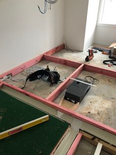 an unfinished room with tools on the floor