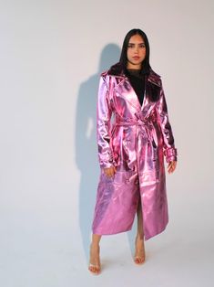 Make a bold statement with this stunning Metallic Pink Vegan Leather Trench Coat. Crafted from cruelty-free materials, this women's long trench coat is the ultimate blend of edgy style and sophistication. Its high-shine metallic finish makes it perfect for festivals, rave wear, or any occasion where you want to stand out. This double-breasted trench coat features classic lapels, a front button fastening, and a self-tie belt for a flattering silhouette. The relaxed fit, long sleeves with buckle-fastened cuffs, and the lightweight feel make this an ideal layering piece for any season. Key Features: -Fabric: SHELL: 50% Viscose, 45% Polyurethane. Lining: 100% Polyester. Durable, cruelty-free vegan leather. -Double-breasted lapels & button fastening: Timeless trench coat style with a modern twi Pink Vinyl Trench Coat, Womens Long Coat, Trench Coats Women Long, Pink Trench Coat, Trench Coat Style, Long Coat Women, Coat Style, Leather Trench, Long Trench